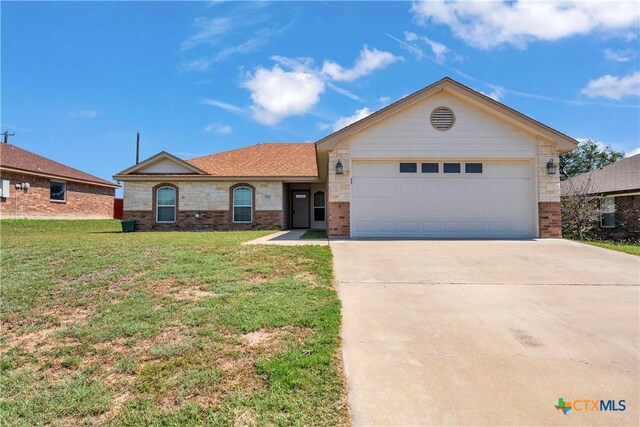 2922 Starlight Dr, Copperas Cove, TX 76522 - view of front facade with brick siding, driveway, a front lawn, and a garage