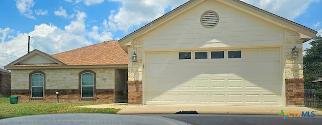 2922 Starlight Dr, Copperas Cove, TX 76522 - view of front of home with brick siding, an attached garage, stone siding, and driveway
