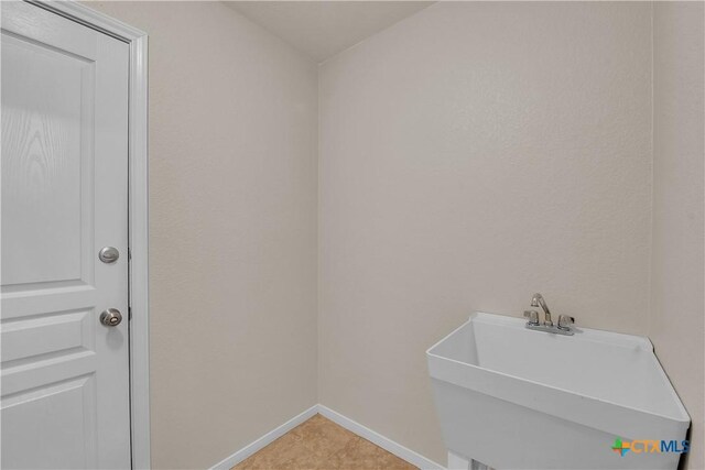 2922 Starlight Dr, Copperas Cove, TX 76522 - washroom with baseboards, a sink, and light tile patterned flooring