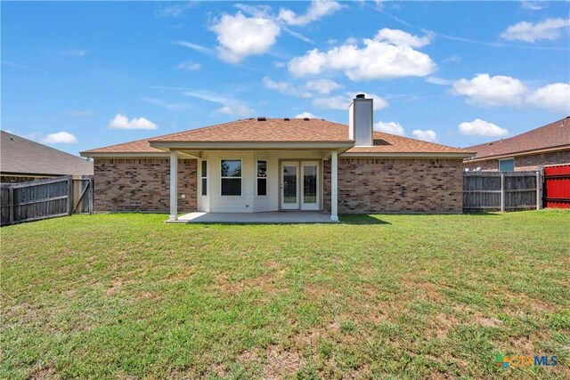 2922 Starlight Dr, Copperas Cove, TX 76522 - rear view of property featuring brick siding, a chimney, a patio area, and french doors