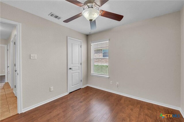 2922 Starlight Dr, Copperas Cove, TX 76522 - unfurnished bedroom with wood finished floors, baseboards, and ceiling fan