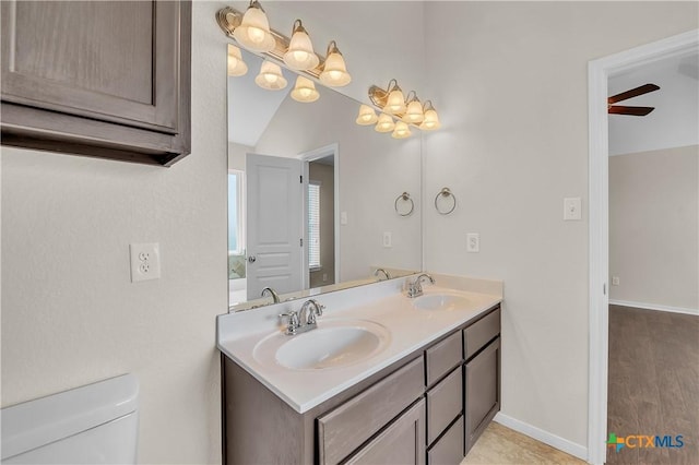 2922 Starlight Dr, Copperas Cove, TX 76522 - bathroom featuring double vanity, toilet, baseboards, and wood finished floors