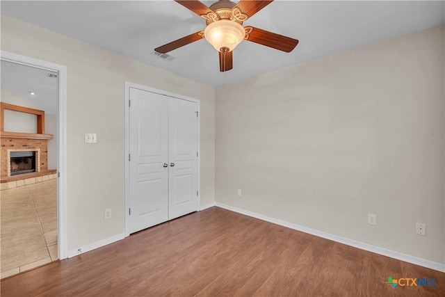 2922 Starlight Dr, Copperas Cove, TX 76522 - unfurnished bedroom with baseboards, wood finished floors, and a fireplace