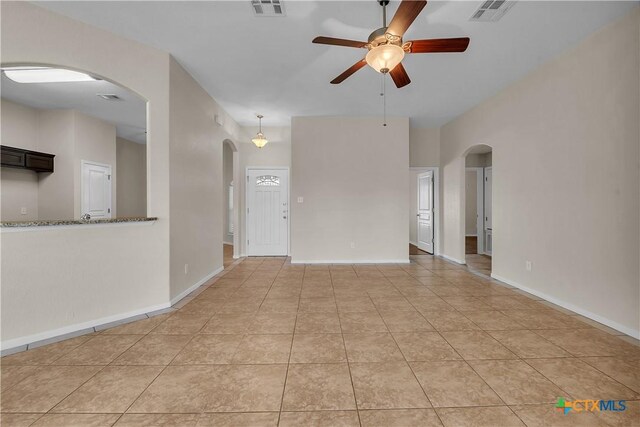 2922 Starlight Dr, Copperas Cove, TX 76522 - spare room featuring arched walkways, ceiling fan, light tile patterned floors, and baseboards