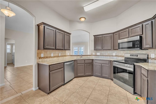 2922 Starlight Dr, Copperas Cove, TX 76522 - kitchen with stainless steel appliances, arched walkways, a sink, and backsplash
