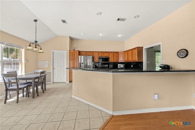 4501 Arrowhead Dr, Temple, TX 76502 - kitchen with black microwave, stainless steel fridge with ice dispenser, brown cabinets, dark countertops, and pendant lighting