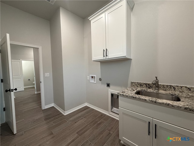 clothes washing area featuring sink, cabinets, dark wood-type flooring, electric dryer hookup, and hookup for a washing machine