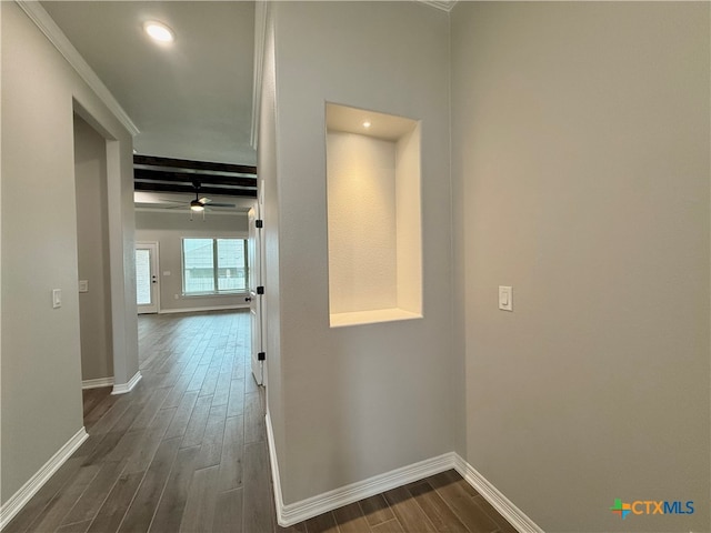 corridor with beamed ceiling, dark hardwood / wood-style floors, and crown molding