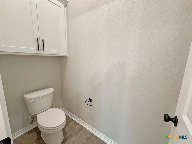 bathroom featuring toilet and hardwood / wood-style flooring