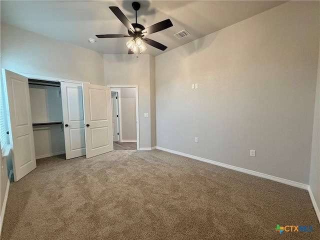 unfurnished bedroom featuring carpet, ceiling fan, and a closet