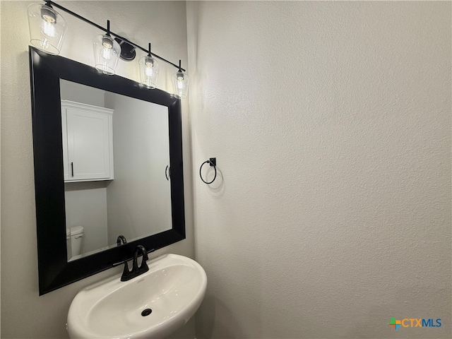 bathroom with toilet and sink