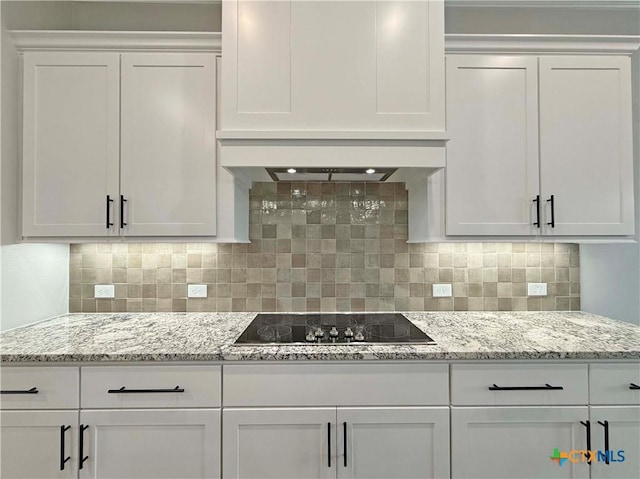 2021 Yarrow Rd, Temple, TX 76502 - kitchen with black electric cooktop, white cabinetry, and decorative backsplash
