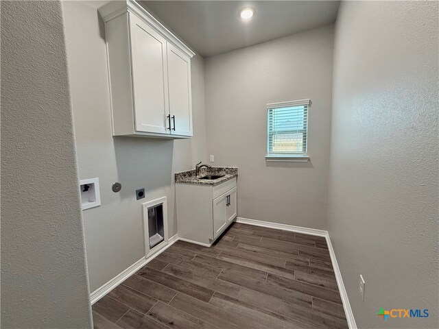 washroom with cabinets, hookup for a washing machine, dark hardwood / wood-style flooring, electric dryer hookup, and sink