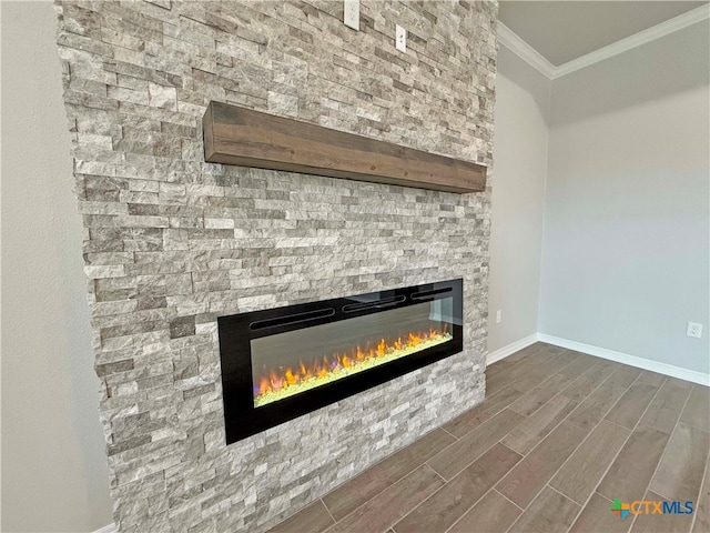 details with hardwood / wood-style floors, a stone fireplace, and ornamental molding