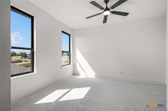 empty room featuring ceiling fan and light colored carpet