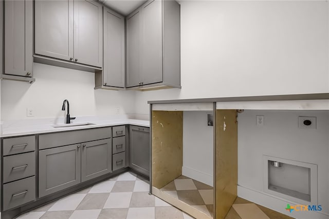 clothes washing area featuring cabinets, electric dryer hookup, and sink