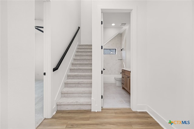 staircase featuring hardwood / wood-style flooring