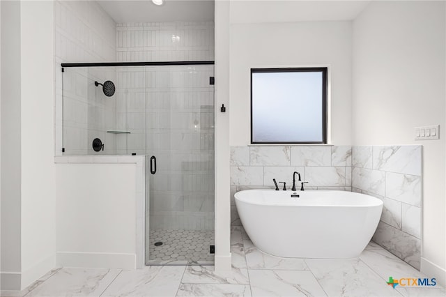 bathroom featuring independent shower and bath and tile walls