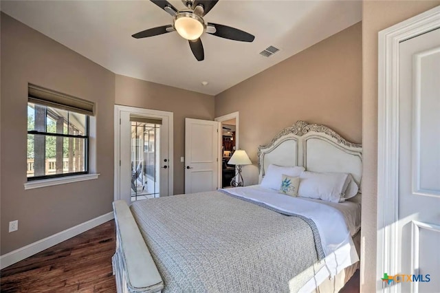 bedroom featuring dark hardwood / wood-style flooring, ceiling fan, and access to outside