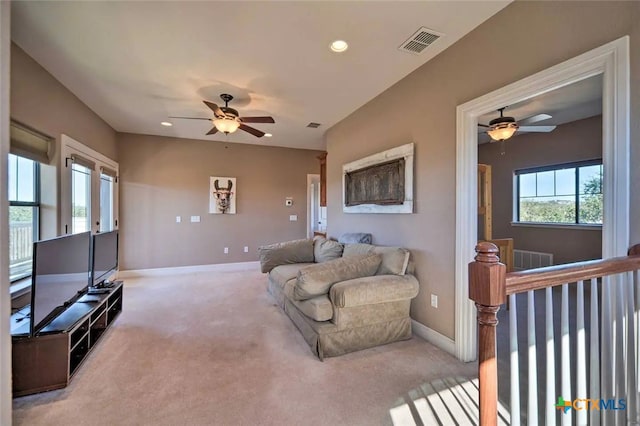 living room with ceiling fan and carpet