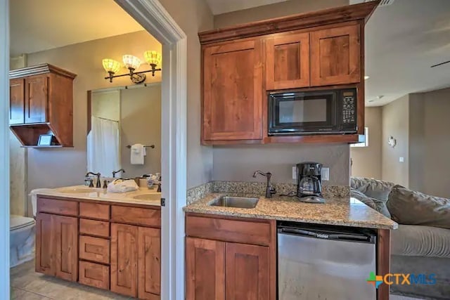 kitchen with sink, black microwave, dishwasher, and light tile patterned floors