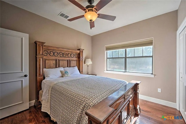 bedroom with dark hardwood / wood-style flooring and ceiling fan