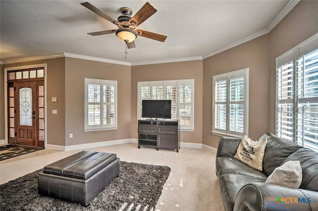 living room featuring ceiling fan, ornamental molding, and light carpet