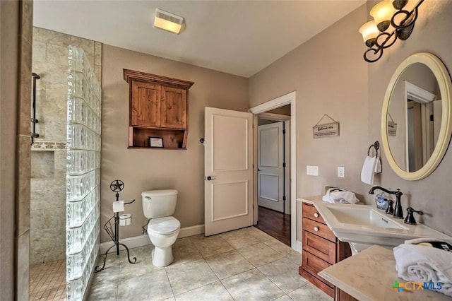 bathroom with sink, tile patterned flooring, a shower, and toilet