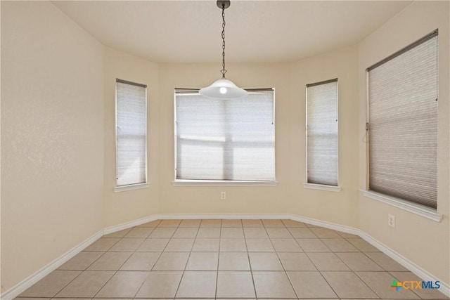 unfurnished dining area with light tile patterned flooring