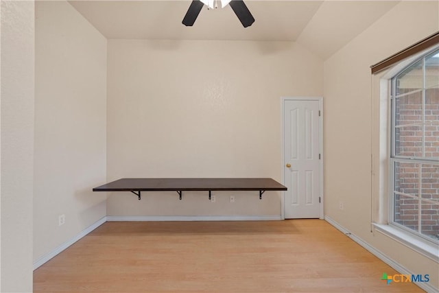 unfurnished room featuring vaulted ceiling, light hardwood / wood-style floors, and ceiling fan