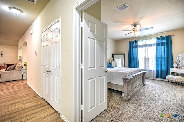 9300 Vaquero Way, Killeen, TX 76542 - bedroom featuring arched walkways, light wood-type flooring, and ceiling fan