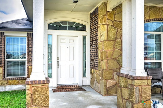 9300 Vaquero Way, Killeen, TX 76542 - view of exterior entry with stone siding, a porch, and a shingled roof