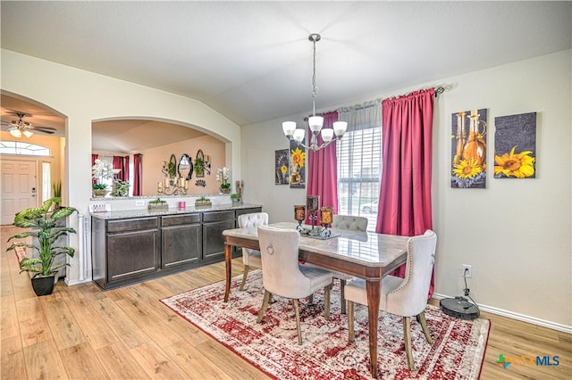 9300 Vaquero Way, Killeen, TX 76542 - dining space with a chandelier, lofted ceiling, light wood-style floors, baseboards, and arched walkways
