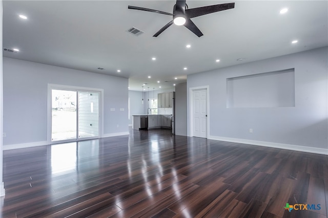 unfurnished living room with ceiling fan, dark hardwood / wood-style floors, and sink