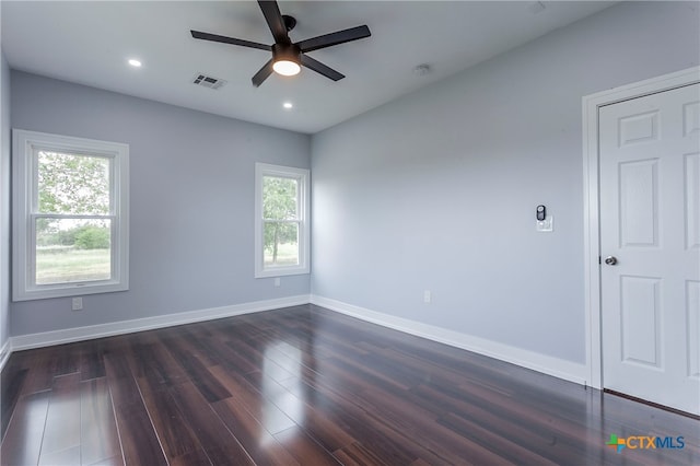 unfurnished room with dark wood-type flooring and ceiling fan