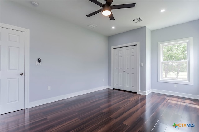 unfurnished bedroom with dark wood-type flooring and ceiling fan