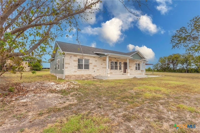 back of house with a patio area and a yard