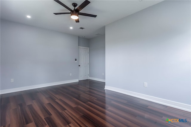 spare room featuring dark hardwood / wood-style flooring and ceiling fan