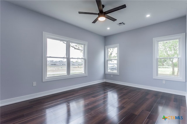 unfurnished room featuring dark wood-type flooring, a wealth of natural light, and ceiling fan