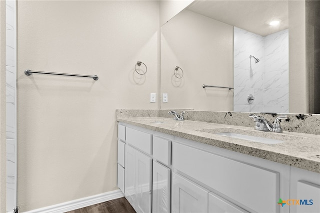 bathroom featuring walk in shower, vanity, and hardwood / wood-style floors