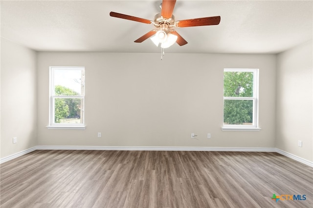 unfurnished room with ceiling fan and light hardwood / wood-style flooring