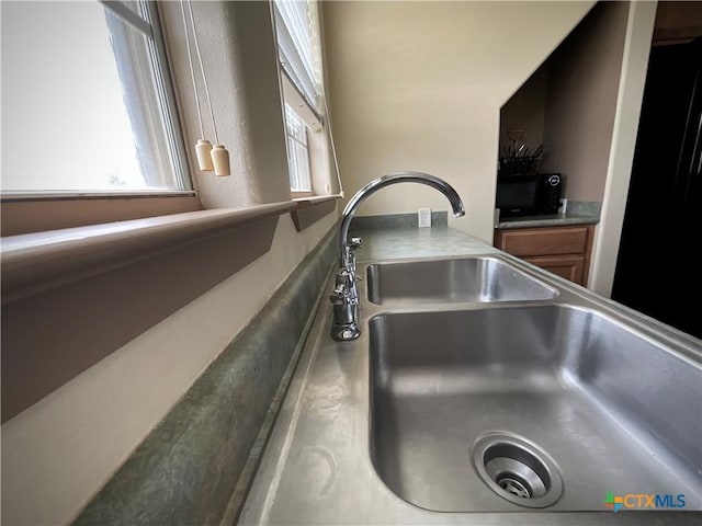 364 N Blackburn Ave, Port Lavaca, TX 77979 - kitchen view of a sink, brown cabinets, and stainless steel countertops