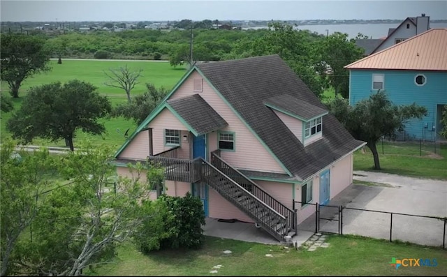 364 N Blackburn Ave, Port Lavaca, TX 77979 - rear view of house featuring a shingled roof, a gate, stairs, and driveway