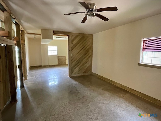 364 N Blackburn Ave, Port Lavaca, TX 77979 - spare room with baseboards, concrete flooring, and a ceiling fan