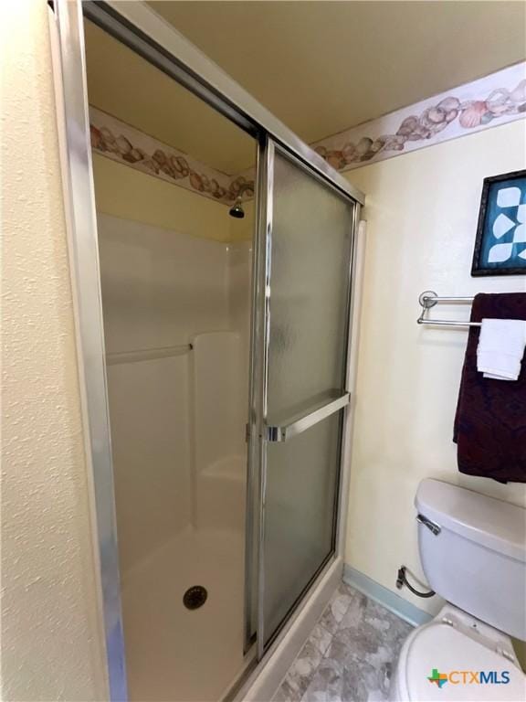 364 N Blackburn Ave, Port Lavaca, TX 77979 - bathroom with a stall shower, toilet, and baseboards