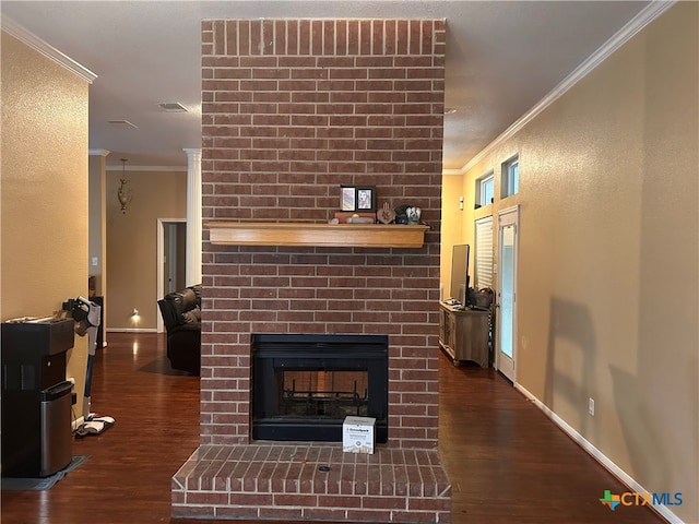 living room featuring crown molding, a fireplace, and dark hardwood / wood-style floors