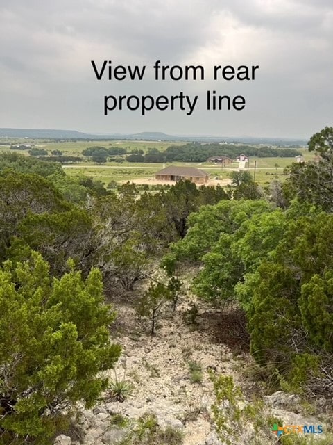 birds eye view of property with a rural view