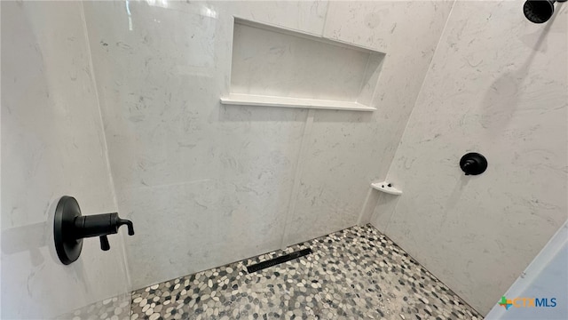 bathroom with tiled shower