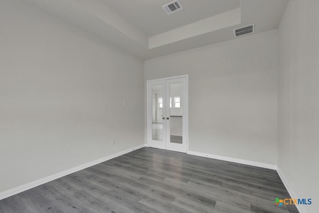129 La Cima, Boerne, TX 78006 - empty room with french doors, a tray ceiling, and dark wood-style floors