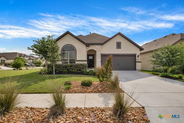 129 La Cima, Boerne, TX 78006 - view of front facade with stucco siding, driveway, a front yard, an attached garage, and stone siding